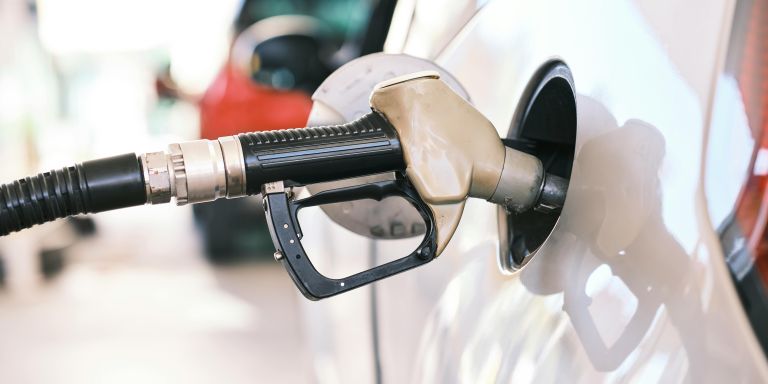 Surtidor de gasolina repostando en un coche blanco – Actualidad de vehículos: Devolución del gasóleo profesional